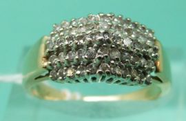 A yellow metal ring marked 14k set with diamonds in a raised cluster (size N)