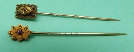 Two 15ct gold stick pins one set with a diamond,