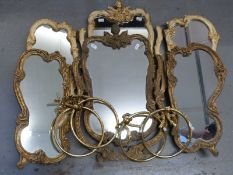 Two ornate triple dressing table mirrors, each decorated with Rococo gilt detail and putti,