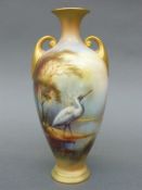 Royal Worcester twin handled pedestal vase decorated with a stork or crane in a continuous