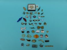 A collection of brooches including glass, enamel, paste, marquesite, ceramic,