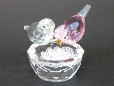 Swarovski style bird bath featuring one pink and one clear bird on a cut glass bowl filled with
