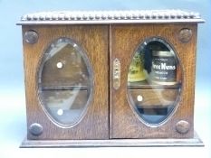 An oak smoker's cabinet, tobacco jar, lighters etc,