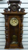 A late 19thC Vienna style regulator wall clock in half turned column case with lion mask decoration,