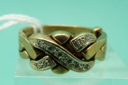 A 9ct gold puzzle ring set with diamonds (size S), weight 6.