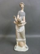A Lladro mother and child figure