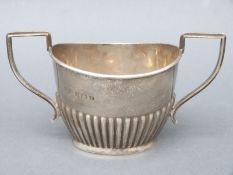 A George VI hallmarked silver two-handled sugar bowl with reeded decoration, B'ham 1939,