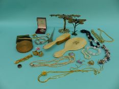 A collection of jewellery including silver bangles, French jet and pearl necklace, three compacts,