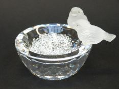 Swarovski bird bath featuring two frosted glass birds with crystal eyes on the side of a clear cut