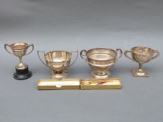Four various mid 20thC hallmarked silver twin handled trophy cups including Ludlow Golf Club,
