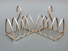 A pair of George V hallmarked silver four-slice toast racks, Sheffield 1919, maker Atkin Brothers,