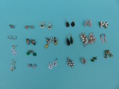 A collection of 21 pairs of silver earrings to include emerald, pearl,