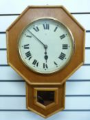 A light wood octagonal cased drop dial single train wall clock, by Ansonia clock company,