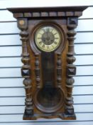 A late 19thC regulator wall clock in carved columned case,