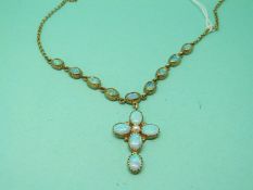 A 9ct gold necklace set with simulated opals with a drop section in the form of a cross