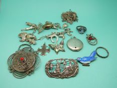 A collection of silver jewellery to include an enamel brooch, silver brooches,