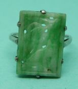 A white metal ring set with a jadeite plaque