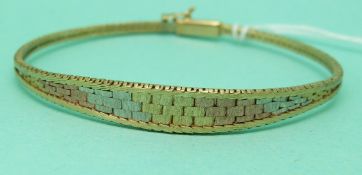 A 9ct tri-coloured bangle (7.