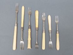 Seven Victorian hallmarked silver bone/ivory or similar handled pickle forks,
