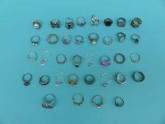 A collection of 37 silver/white metal rings including pearl, topaz,