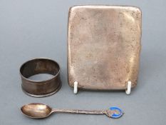 A hallmarked silver cigarette case, napkin ring and spoon,