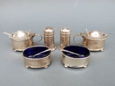 Two George V hallmarked silver three-piece condiment sets comprising mustard pots,