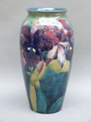 A Moorcroft vase decorated with irises on a green ground, 26cm tall,