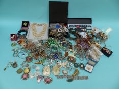 A large collection of costume jewellery to include brooches, necklaces,