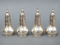 A set of four Edward VII hallmarked silver peppers, Sheffield 1904, maker Atkin Brothers,