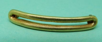 A yellow metal hair clip