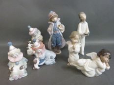 A collection of boxed Lladro child figures including clowns & Little Fireman
