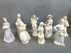 A collection of Nao figures each holding or with animals or birds