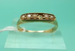 A 14ct gold ring set with pearls (Size O)