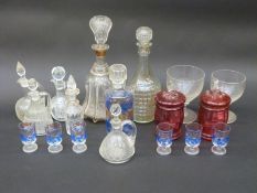 A collection of clear and coloured glassware including two rummers, cranberry pots, decanters,