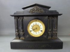 A late 19thC black slate mantel clock in classical architecture style with reeded Roman columns