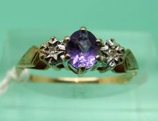 A 9ct gold ring set with an amethyst and two diamonds (size J)