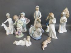 A collection of Nao child figures including babies, shoeshine, boy on phone with puppy,