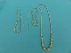 Two ivory necklaces and a carved bone example