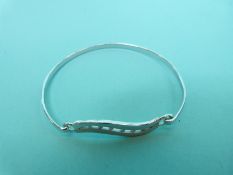 A silver pendant and bangle set with cubic zirconia