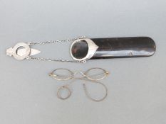 A hallmarked silver mounted hanging faux tortoiseshell spectacle case,