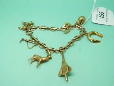 A 9ct gold charm bracelet with five 9ct gold charms including horse, Concorde, stag,