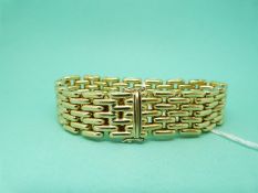 An 18ct gold 'Cartier' style bracelet of polished links,