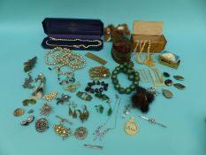 A collection of costume jewellery to include mother of pearl buckles, brooches,