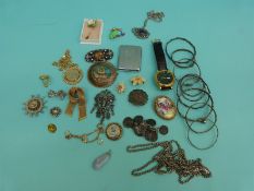 A collection of jewellery to include Miracle brooch, Lorus watch, white metal bangles,