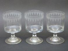 Three Georgian glass rummers with etched decoration raised on knopped stems,