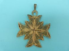 A silver gilt large filigree pendant in the form of a Maltese cross with blue and white enamel