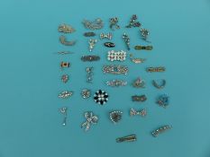 A collection of brooches to include floral brooches, enamel,