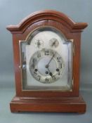 A three train Junghans mantel clock with silvered Arabic dial,