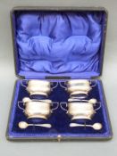 A cased set of George V hallmarked silver two handled open salts,