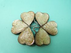 A silver buckle set with six panels of mother of pearl in the form of a clover/ shamrock